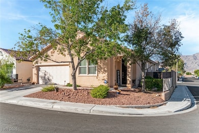 View of front of house with driveway, stucco siding, an attached garage, and a mountain view