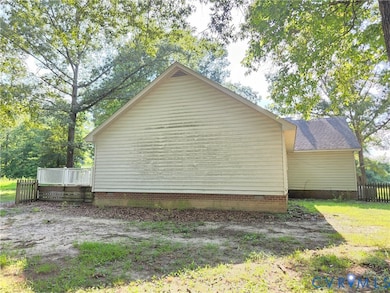 View of side of property featuring a deck and crawl space