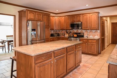 The kitchen has stainless steel appliances, a cent