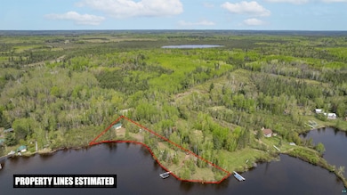 View of property location featuring a heavily wooded area, property boundaries highlighted, and a nearby body of water