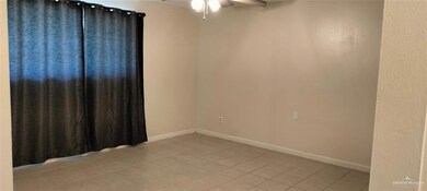 Spare room with baseboards, ceiling fan, and light tile patterned flooring