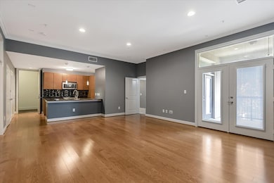 Spacious living area with hardwood floors and an open layout.
