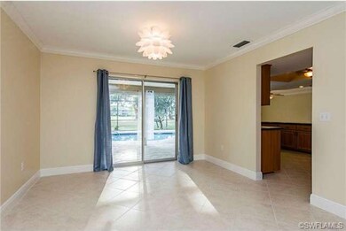 Formal dining room with sliders to lanai/pool