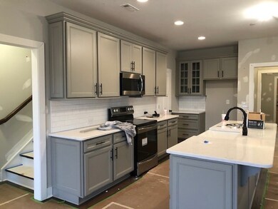 Gorgeous farmhouse kitchen.... Beautiful gray cabinets w/ soft close drawers, end panels and glass cabinet doors.