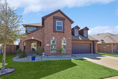 View of front of house featuring a front lawn and a garage