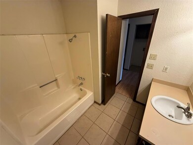Full bath featuring tile patterned floors, vanity,