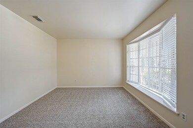 The standout feature in this living room is the bay window, which extends outward from the room and allows an abundance of natural light to flood in, creating a bright and inviting atmosphere.