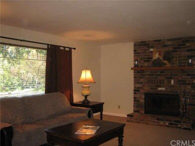 Large living room with brick fireplace that is als