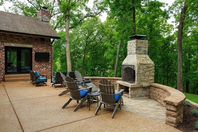 Rear Patio with Fireplace and seating area with TV