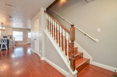 As you enter the home you can see the wood plank flooring flow into dining, kitchen and den area.
