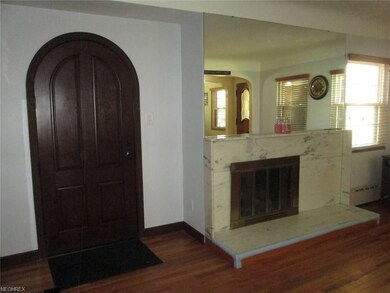 Living room with a gas fireplace, hardwood floors 