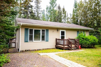 View of front facade with a deck and a front yard
