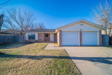 Ranch-style home with a garage and a front yard