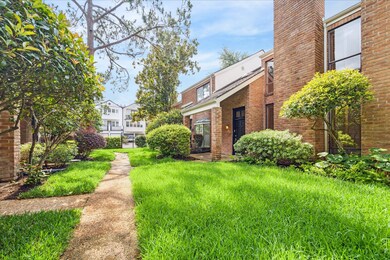 Manicured walkway winds through lush landscaping t
