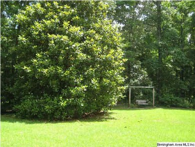 View of back yard with swing and large beautiful m