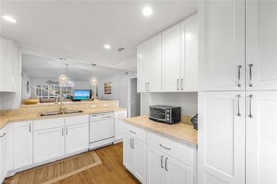 Kitchen with visible vents, dishwasher, light coun