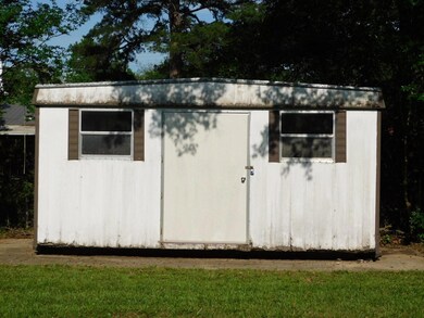 View of outdoor structure with a lawn