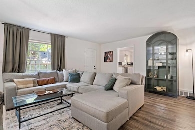 Living room featuring a textured ceiling and wood finished floors