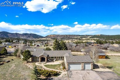 Aerial view of home showing three car garage and f