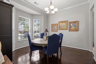 Dine in style! This bright and inviting dining room showcases gorgeous wood floors and sunlit bay windows, creating an ideal space for memorable meals.
