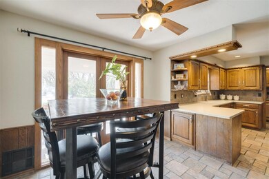 Kitchen featuring ceiling fan, kitchen peninsula, 