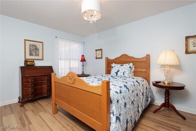 Bedroom featuring baseboards and wood finished flo