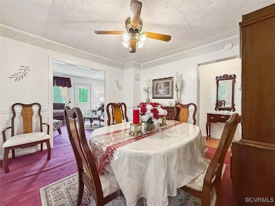 Dining space with a textured ceiling, a ceiling fa