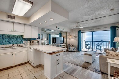Kitchen featuring white cabinetry, white dishwashe