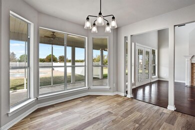 Wall of windows offers great backyard views and tree lined landscape.