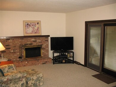 Family room with wood burning fireplace and Pella 