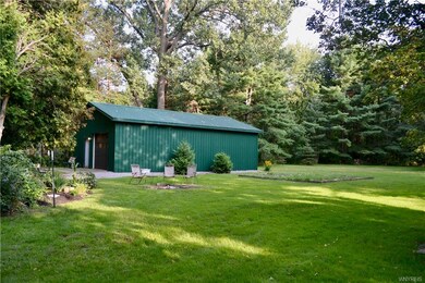 View of the 40x24 pole barn, fire pit & veggie gar