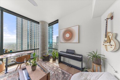 Living room with baseboards, expansive windows, w