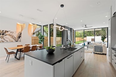 Kitchen featuring dark countertops, modern cabine