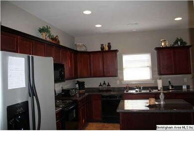 Kitchen features Rich cherry wood cabinets Granite
