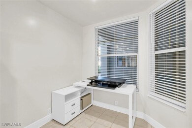 Office area featuring light tile patterned floors