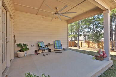 Beautiful patio with ceiling fan! Back yard surrounded with mature trees, great for shade and privacy.