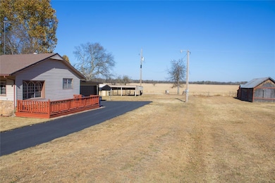 View of yard with a deck, an outdoor structure, and a view of rural / pastoral area