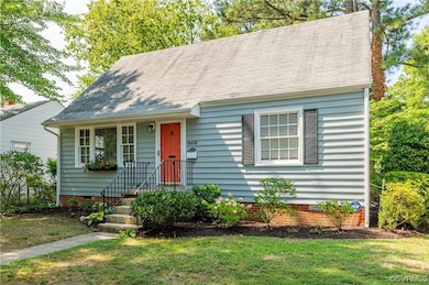 New england style home with a front lawn
