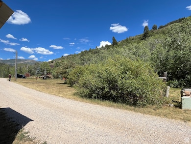 View of dirt / gravel road featuring a mountain view
