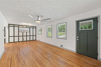Unfurnished room featuring a textured ceiling, cei