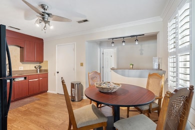 Dining space featuring a ceiling fan, light wood-s