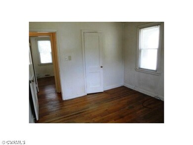 Bedroom - This airy bedroom has wood floors and is