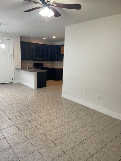 Kitchen featuring backsplash, a ceiling fan, a pe