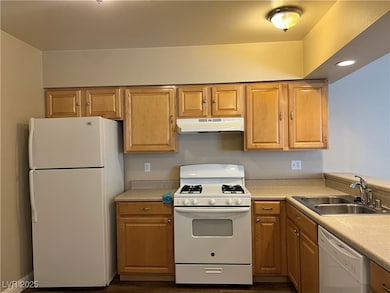 Kitchen featuring white appliances, under cabinet