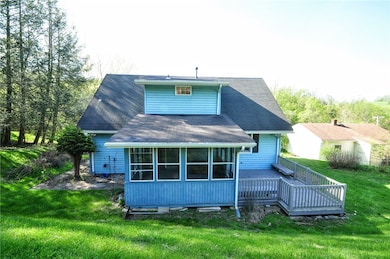 The back of the home showing the sunroom and deck