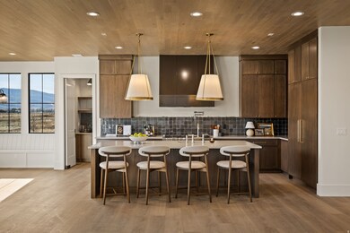 Kitchen featuring a breakfast bar, a mountain view, decorative light fixtures, recessed lighting, and light wood-type flooring