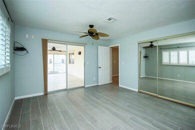 Unfurnished bedroom with baseboards, wood tiled fl