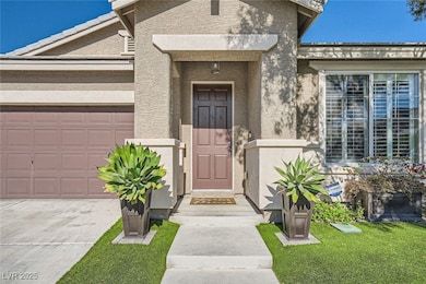 Property entrance with stucco siding, a garage, an