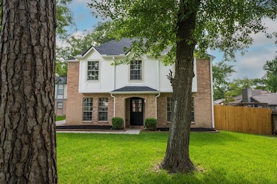 A stunning front yard with mature trees that provi