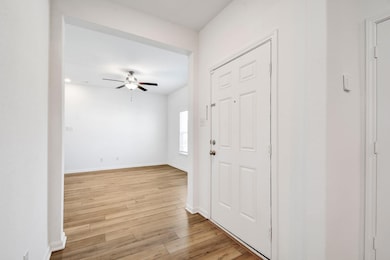 Entryway featuring light wood-style flooring and ceiling fan